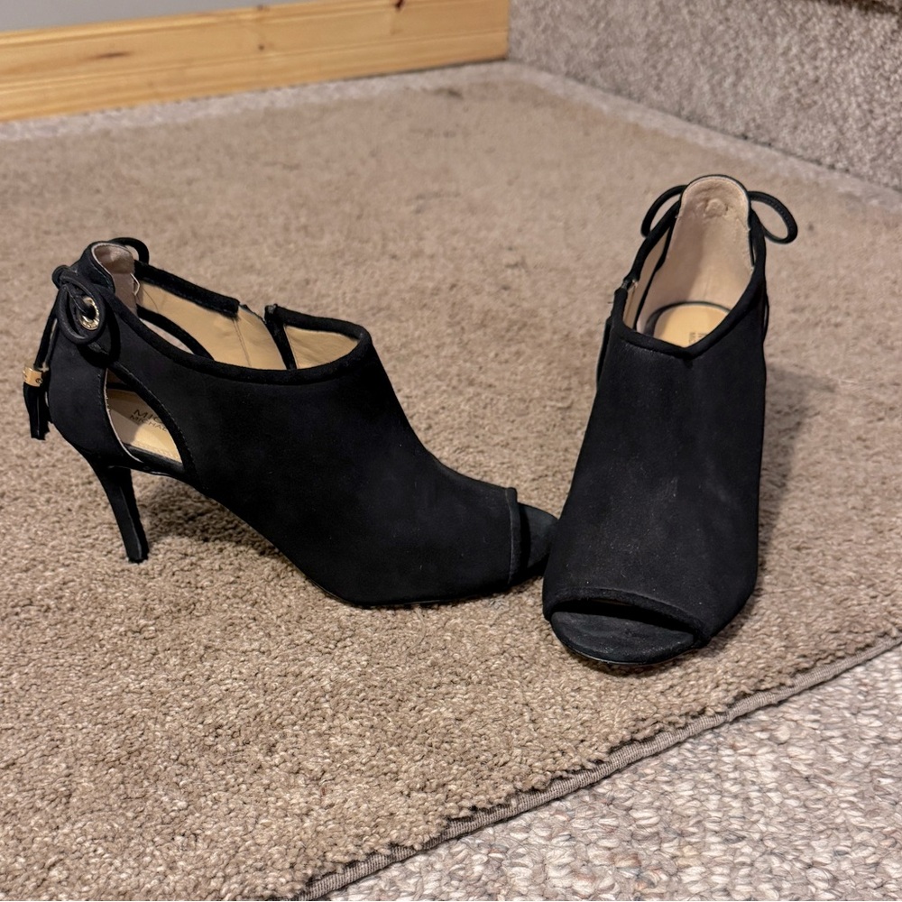Michael Kors black Jennings black suede peep-toe booties.